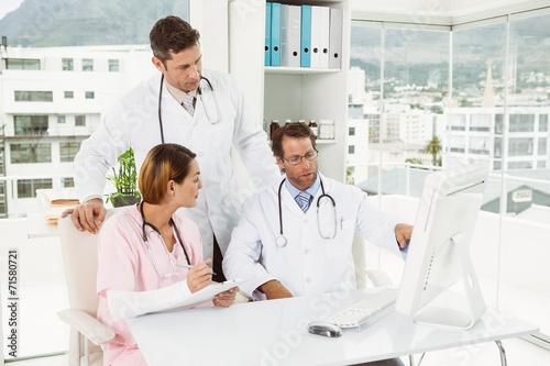 Doctors using computer at medical office