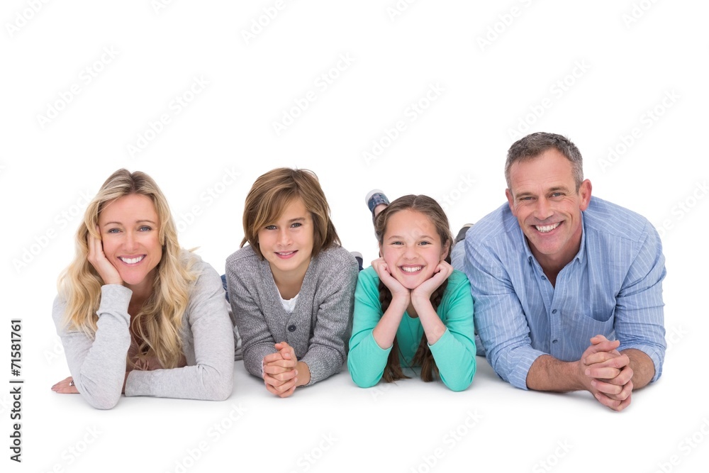 Cute family lying on the floor smiling at camera Cute family lying on the floor smiling at camera