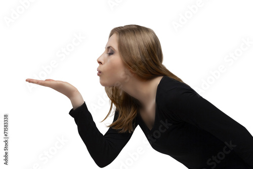 young girl blowing