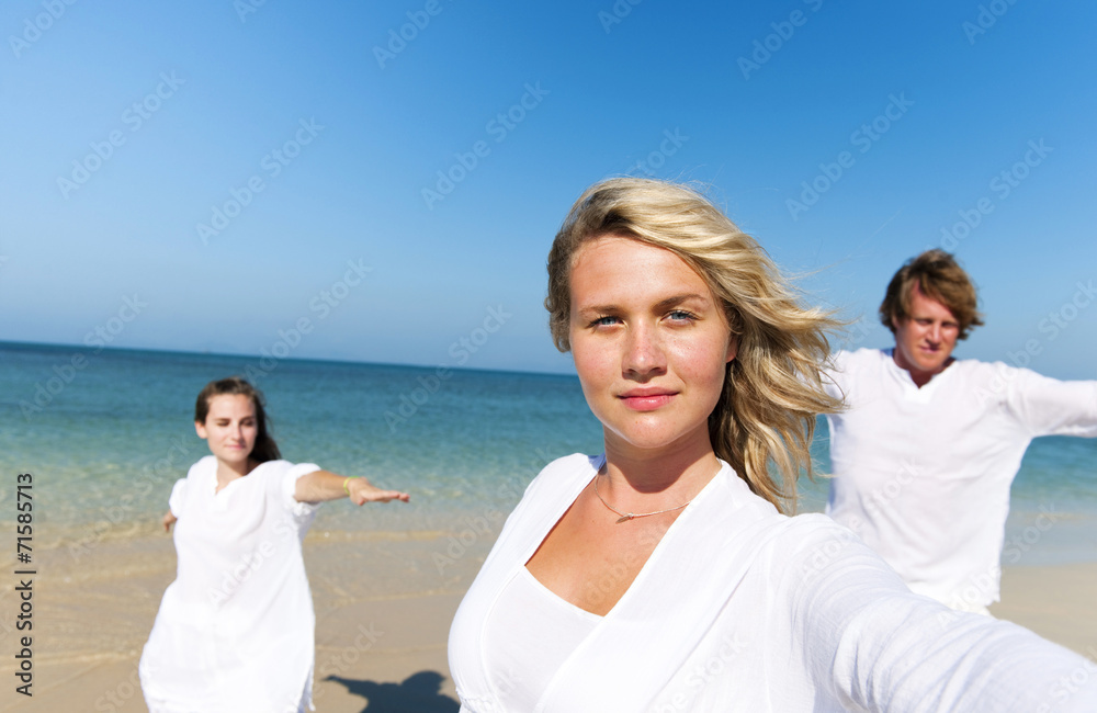 Obraz premium People Performing Yoga on the Beach