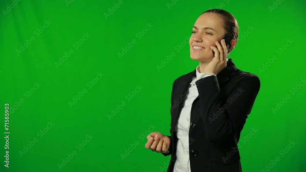 Pretty businesswoman talking on the phone, green background