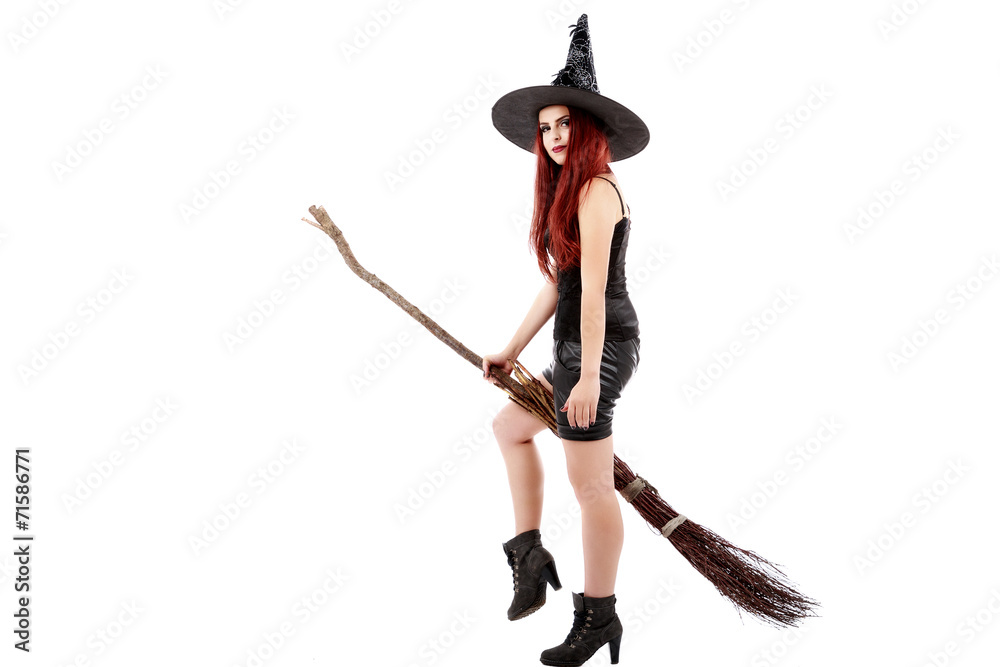 happy young witch with a broom, isolated on white studio backgro happy young witch with a broom, isolated on white studio backgro