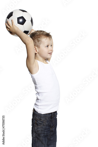 Young boy holding soccer ball, studio