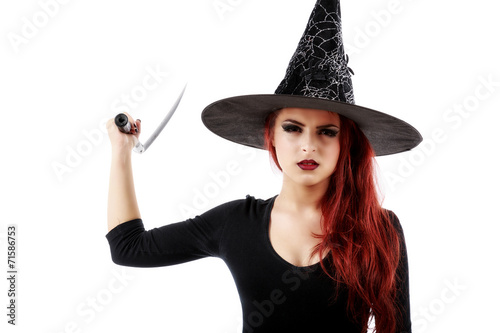Young witch with scythe isolated on white © czamfir