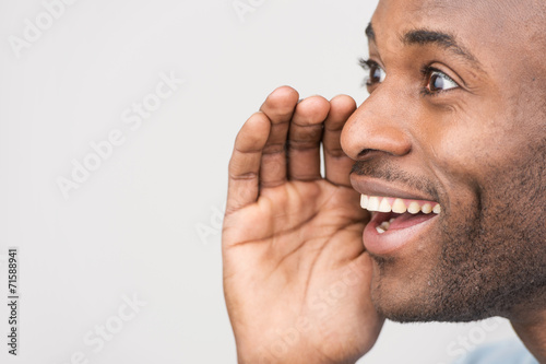 Foto Handsome young men gossiping while standing isolated on white.