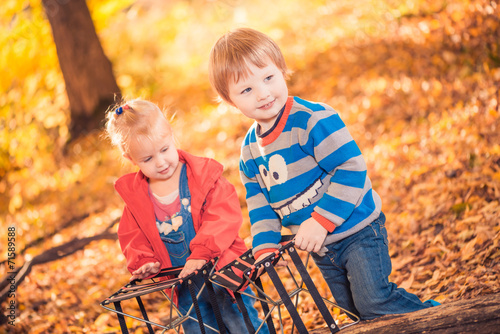 boy and girl playing at fall forest
