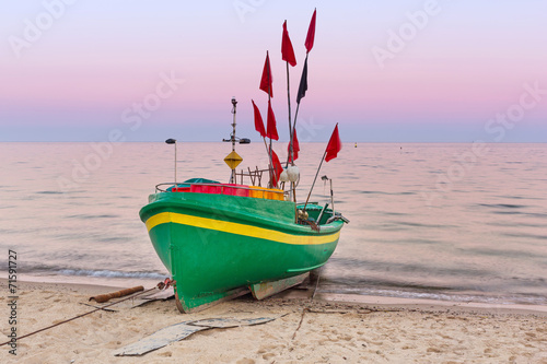 Fototapeta Naklejka Na Ścianę i Meble -  Baltic beach with fishing boat at sunset, Poland