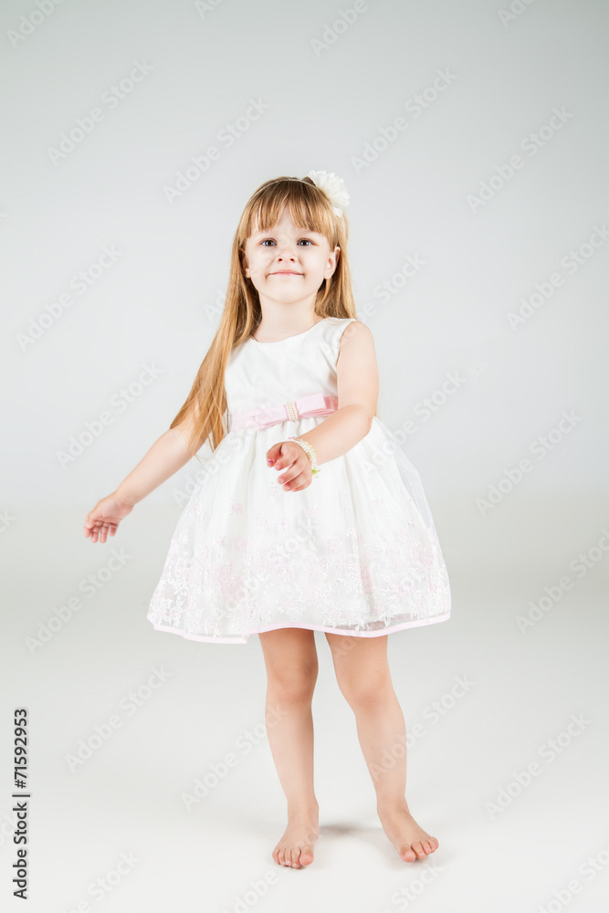 Little fashion girl in beautiful dress posing Little fashion girl in beautiful dress posing