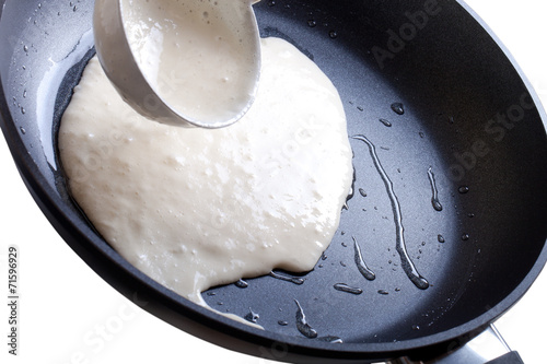 Pour batter into the pan. Isolated on white background. Sharpnes photo