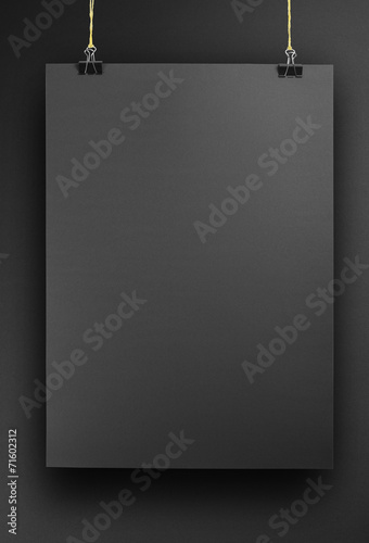 Black poster on a rope.