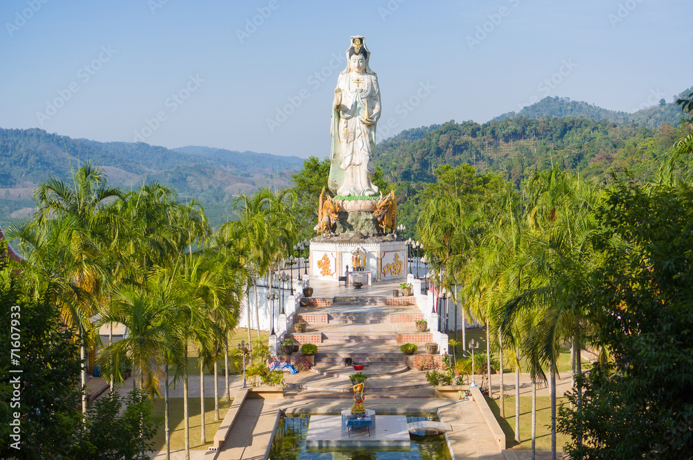 Statue of Guan Yin / Kuan Im goddess and pool in front in Wat Ba