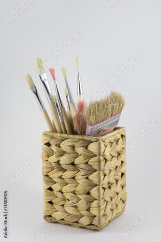 Set of paintbrushes in a pot photo