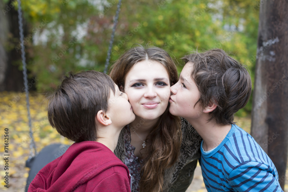 two boys kissing a teenage girl