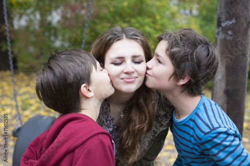 two boys kissing a teenage girl