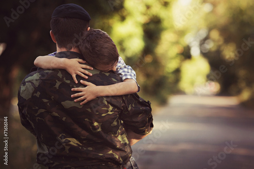 Woman and soldier in a military uniform say goodbye