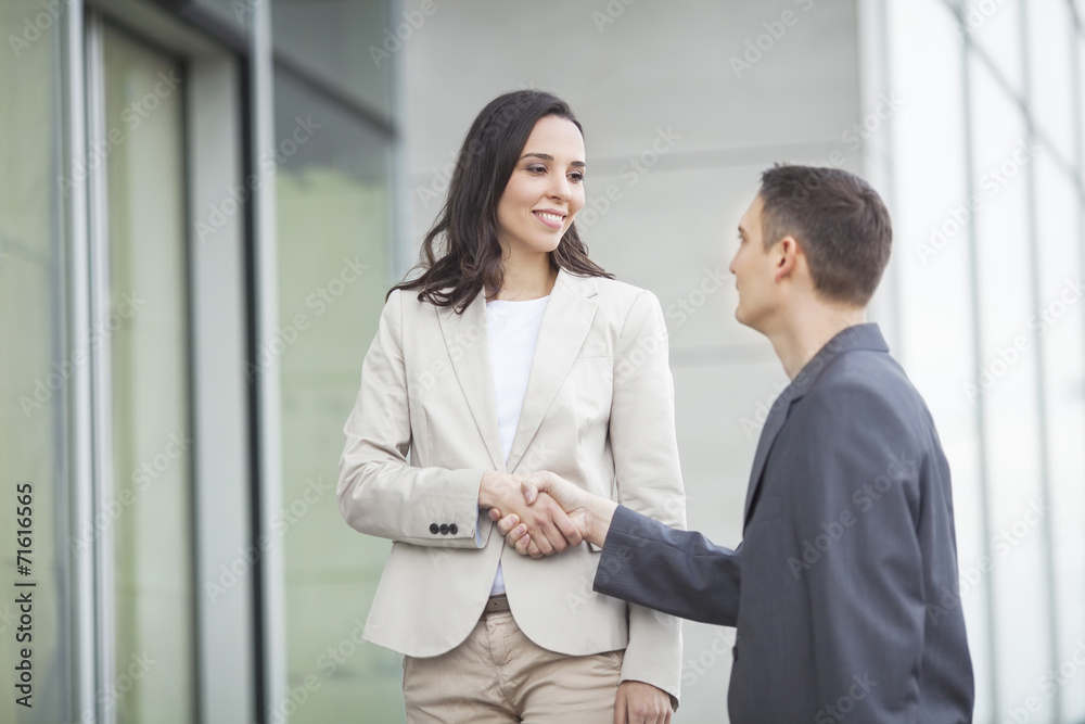 Businesswoman shaking hands with businessman Businesswoman shaking hands with businessman