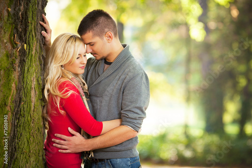 Young couple embracing on a sunny autumn day in nature
