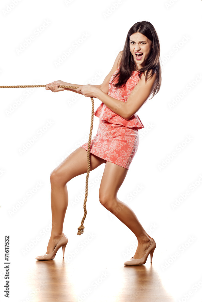 young pretty woman pulling a rope Stock Photo