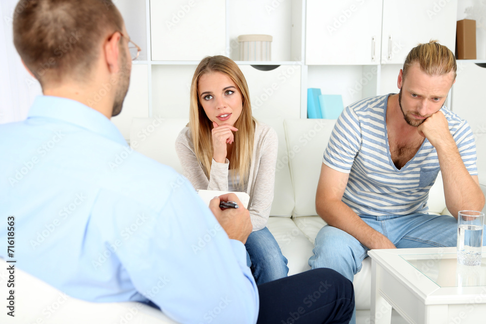 Unhappy couple not talking on couch at therapy session Unhappy couple not talking on couch at therapy session