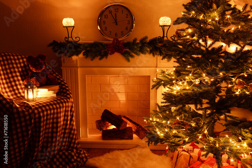 Christmas tree near fireplace in room