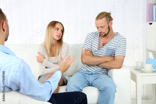 Unhappy couple not talking on couch at therapy session