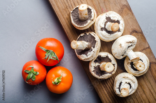 Tomato and mushrooms on wood