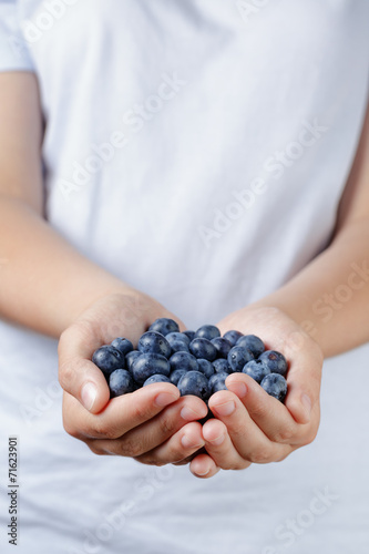 fresh washed blueberries in female teen hands
