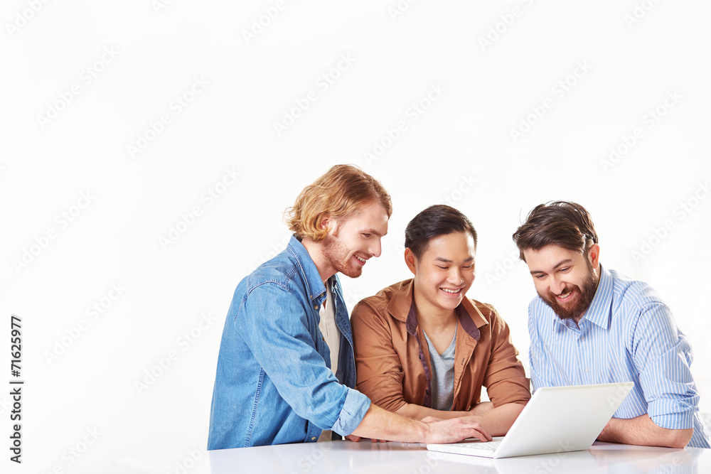 Group of cheerful men working on laptop Group of cheerful men working on laptop