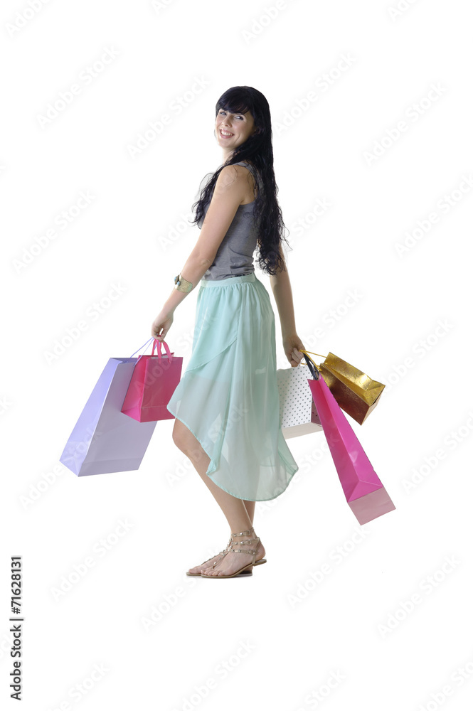 Young attractive girl walking shopping bags isolated on white