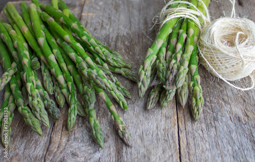 ripe green asparagus on a wooden background