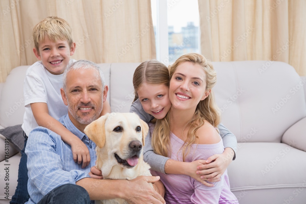 Parents and children on rug with labrador Parents and children on rug with labrador