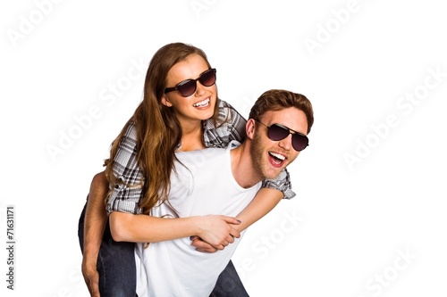 Smiling young man carrying woman