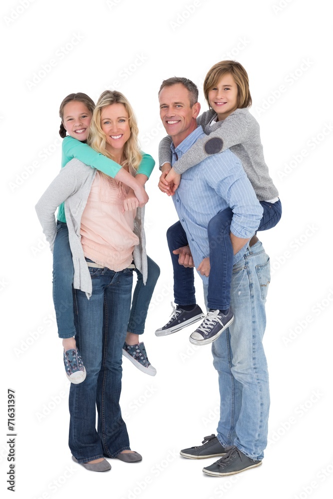 Happy two parent giving their children a piggy back Happy two parent giving their children a piggy back