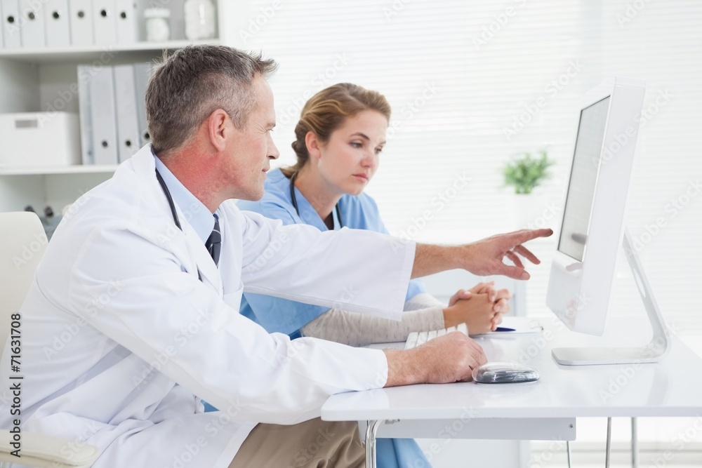 Doctor and nurse looking at a computer Doctor and nurse looking at a computer