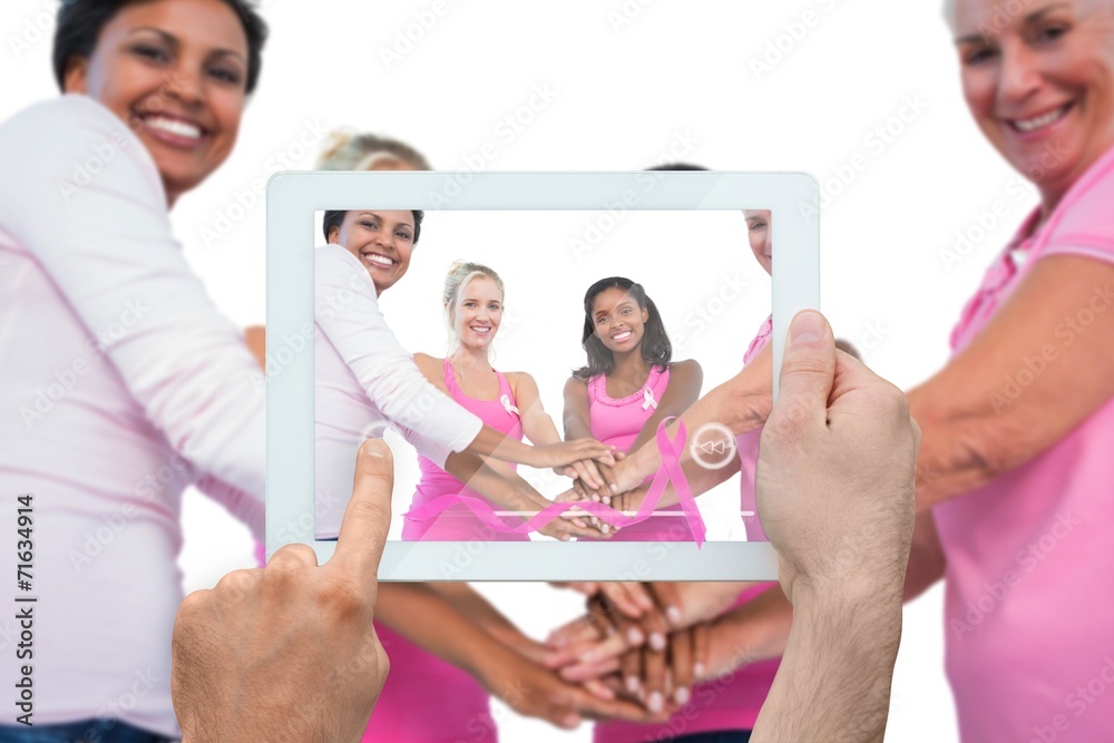 Fototapeta premium Composite image of hand holding tablet pc