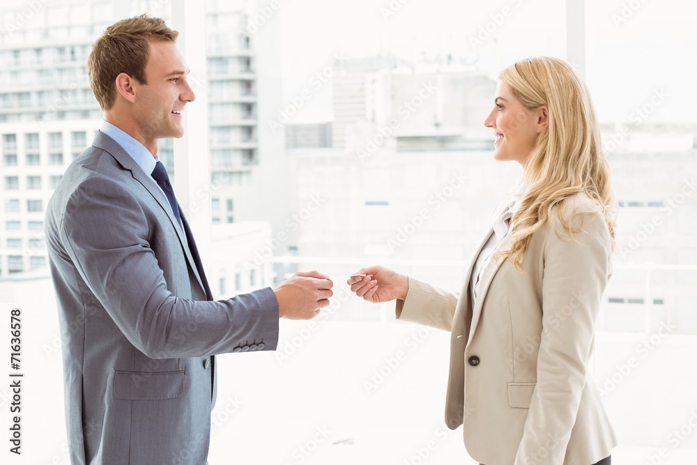 Executives exchanging business card in office