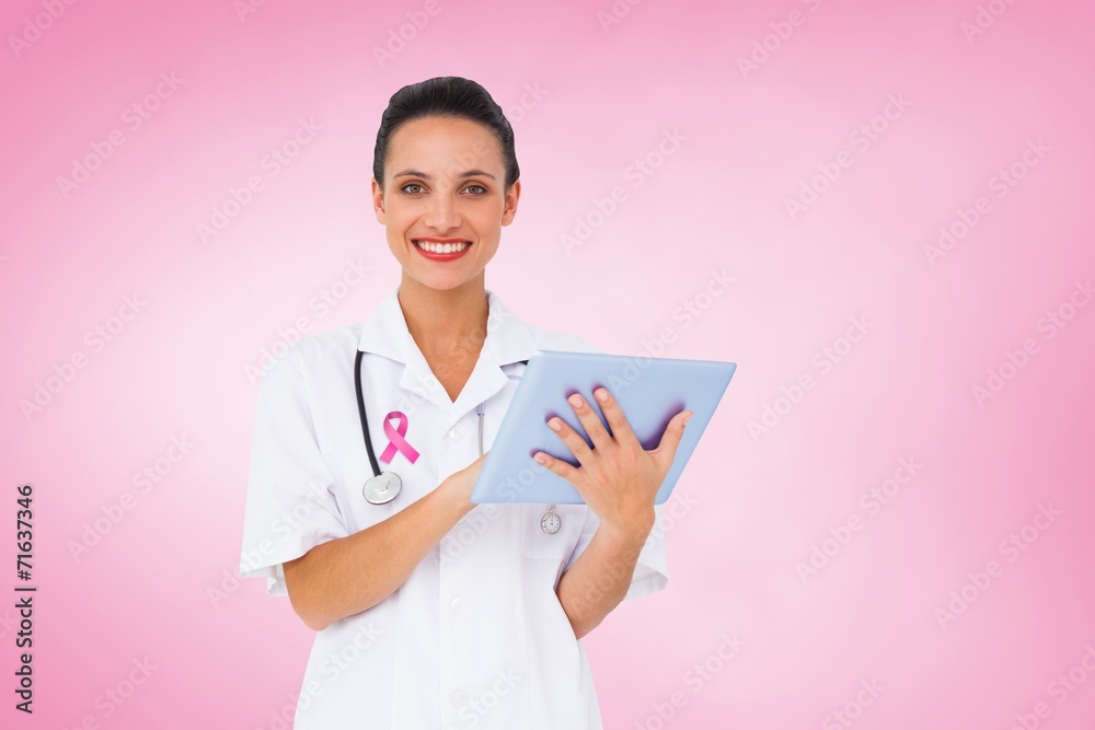 Composite image of pretty nurse using tablet pc Composite image of pretty nurse using tablet pc
