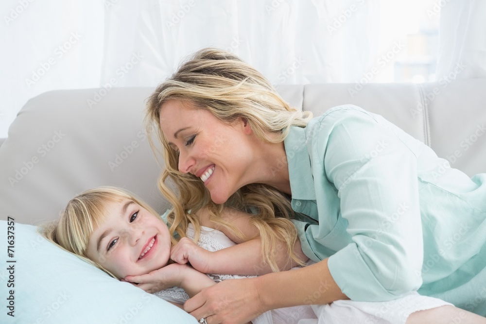 Beautiful mother and daughter lying on the couch Beautiful mother and daughter lying on the couch
