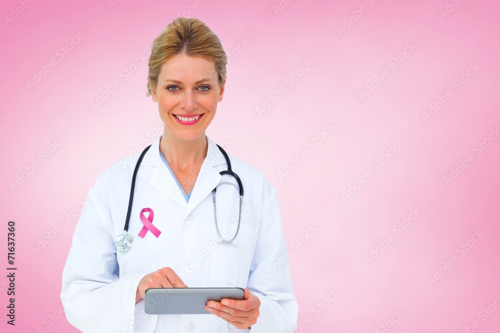 Composite image of blonde doctor using tablet pc Composite image of blonde doctor using tablet pc