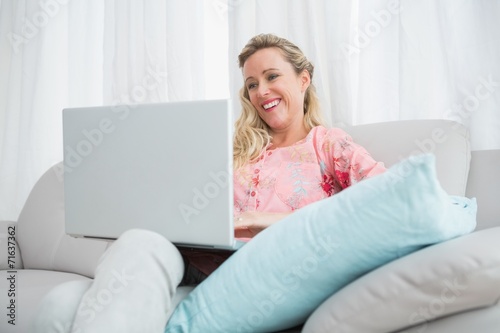 Beautiful blonde woman using laptop