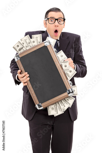Tablou canvas Scared businessman holding a bag full of money