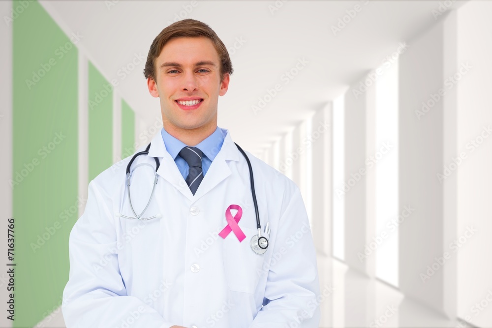 Composite image of young doctor using tablet pc Composite image of young doctor using tablet pc