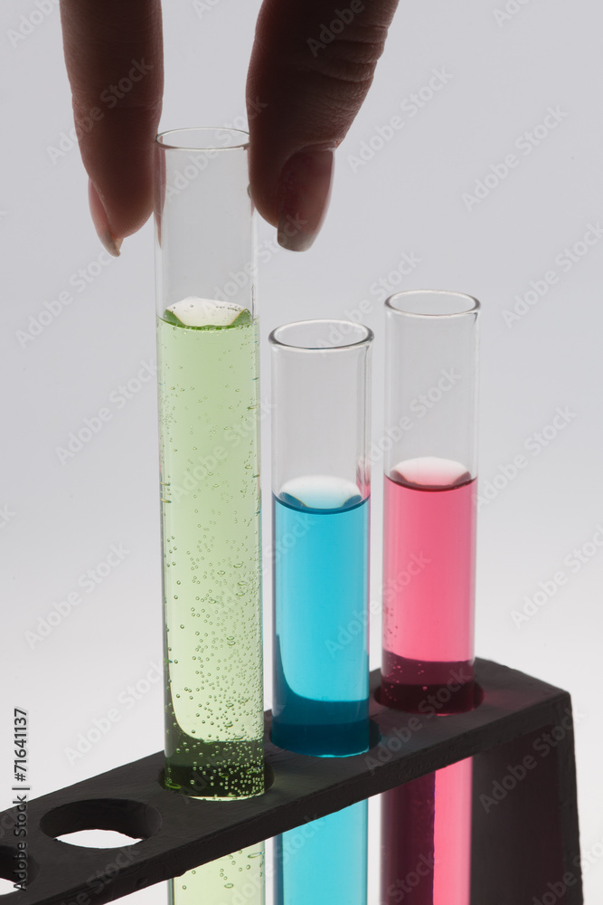 A researcher pull out one test tube, isolated on gray background