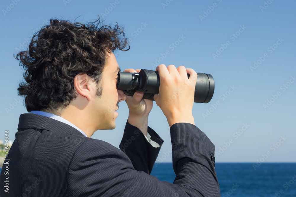 businessman looking at the sky with binoculars businessman looking at the sky with binoculars