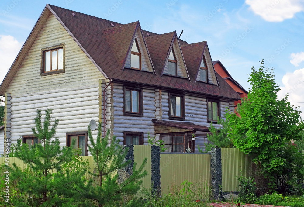 Suburban cottage of wooden logs