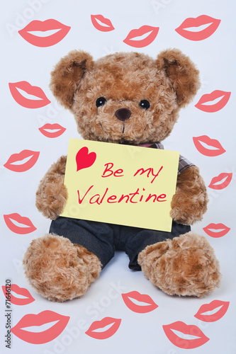Teddy bear holding a yellow sign that says Be my Valentine © David Davis