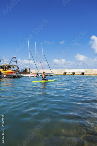 woman floats in a canoe