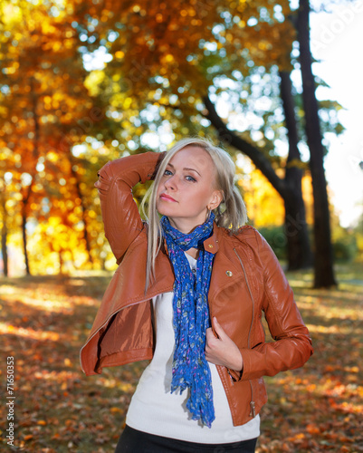 Pretty girl posing in autumn park