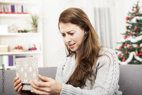young girl is unhappy about her christmas gift