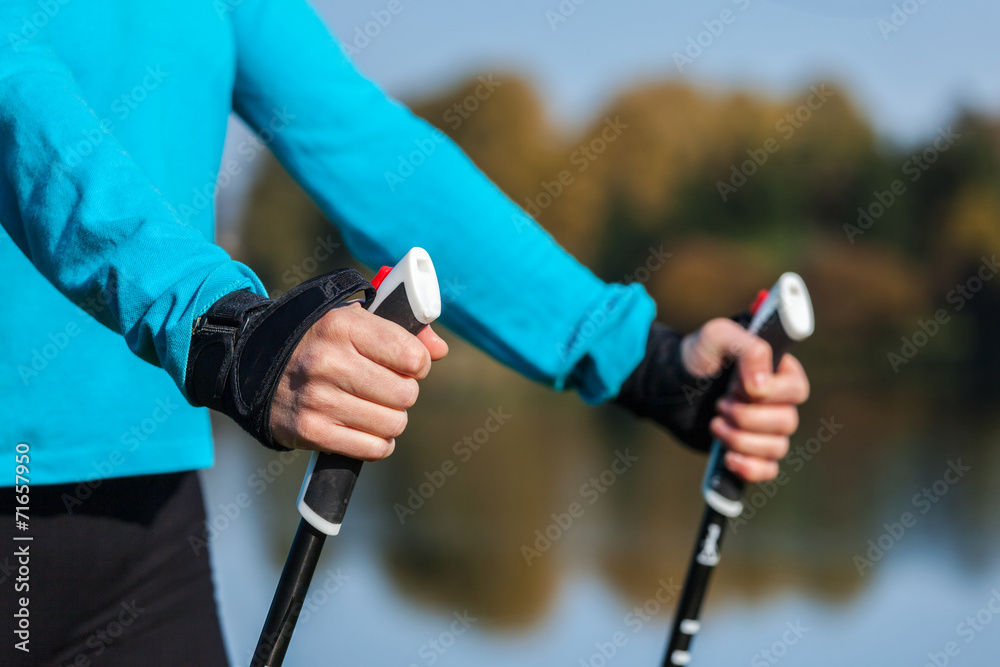 Closeup of woman's hand with nordic walking poles